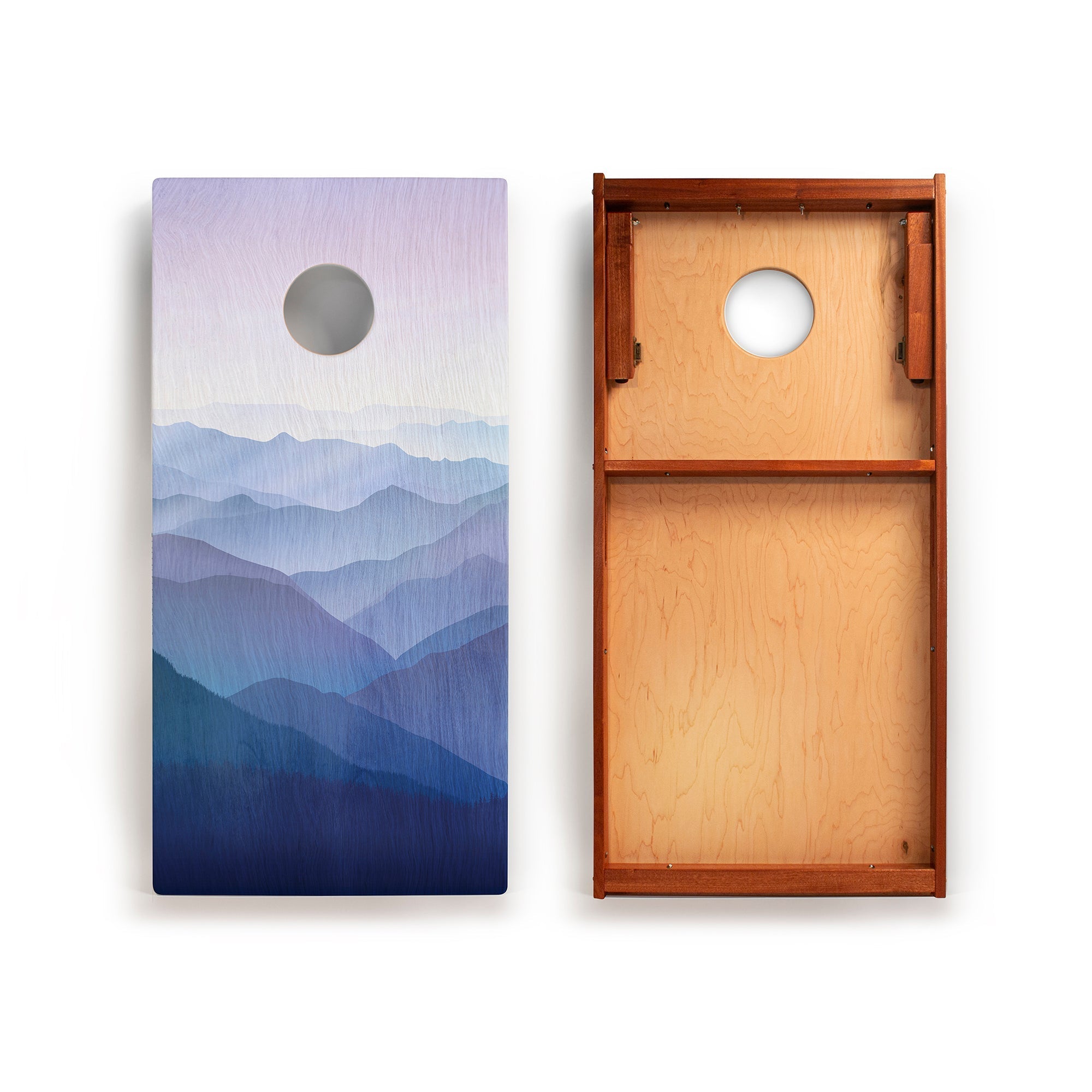 Two wooden boards with mountain and circular designs on a white background