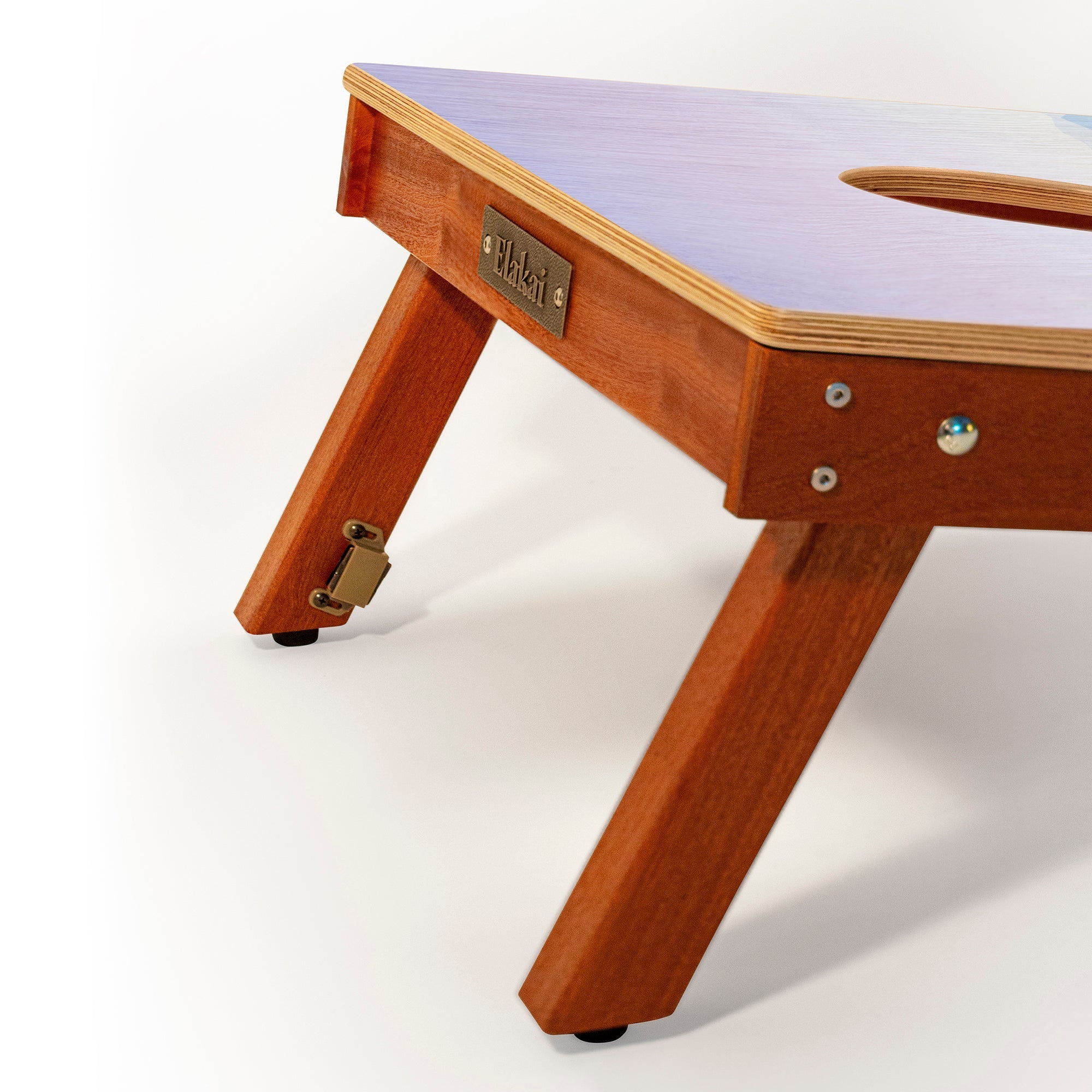 Wooden table with a purple surface on a white background