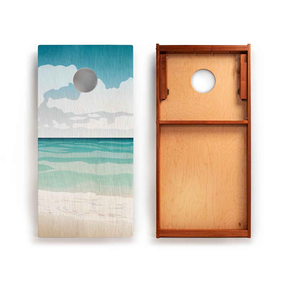 Two wooden boards with one featuring a beach scene design and the other plain.
