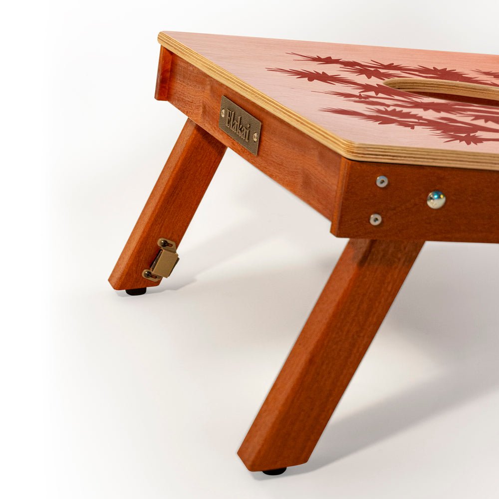 Wooden table with a brand label on a white background