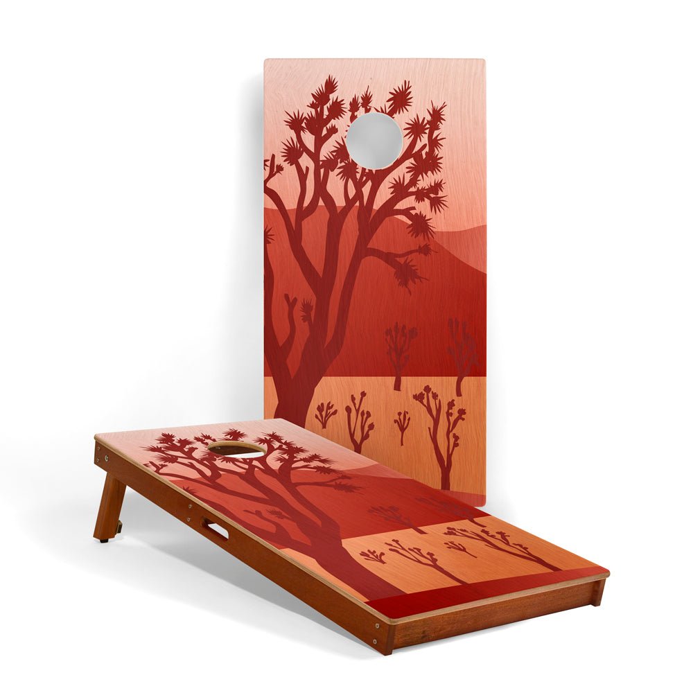 Cornhole board set with desert landscape design on a white background