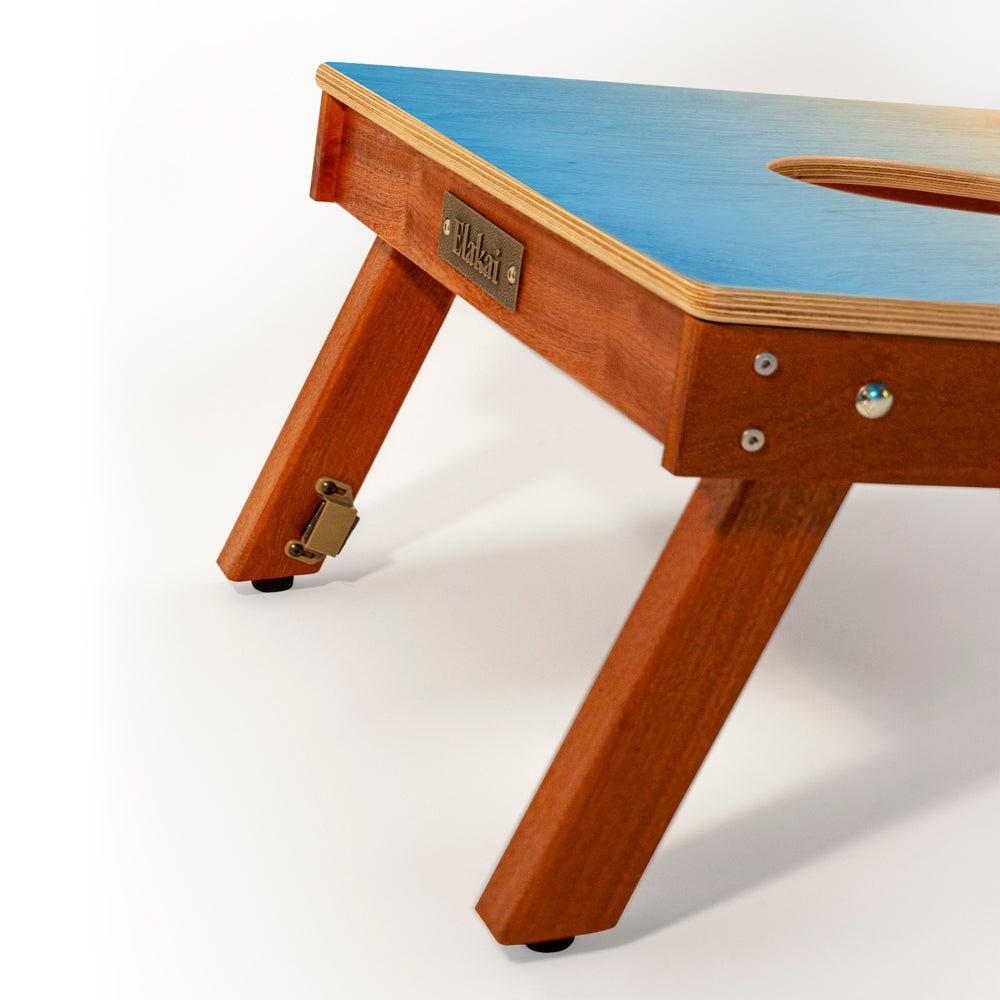 Wooden table with blue top on a white background