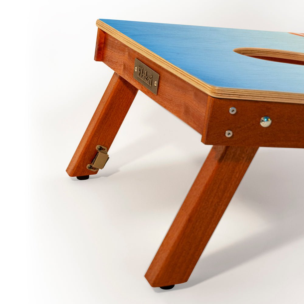 Wooden table with blue top on a white background