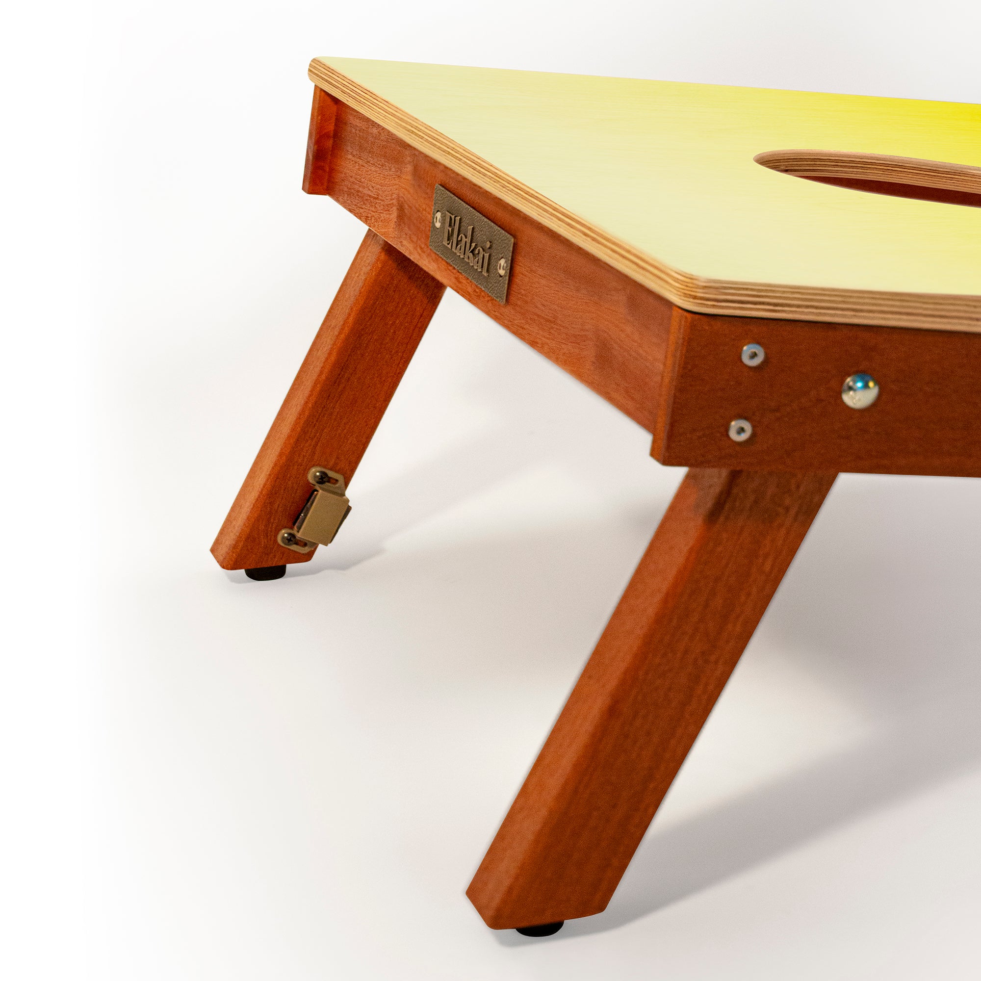 Wooden children's table with a yellow top on a white background