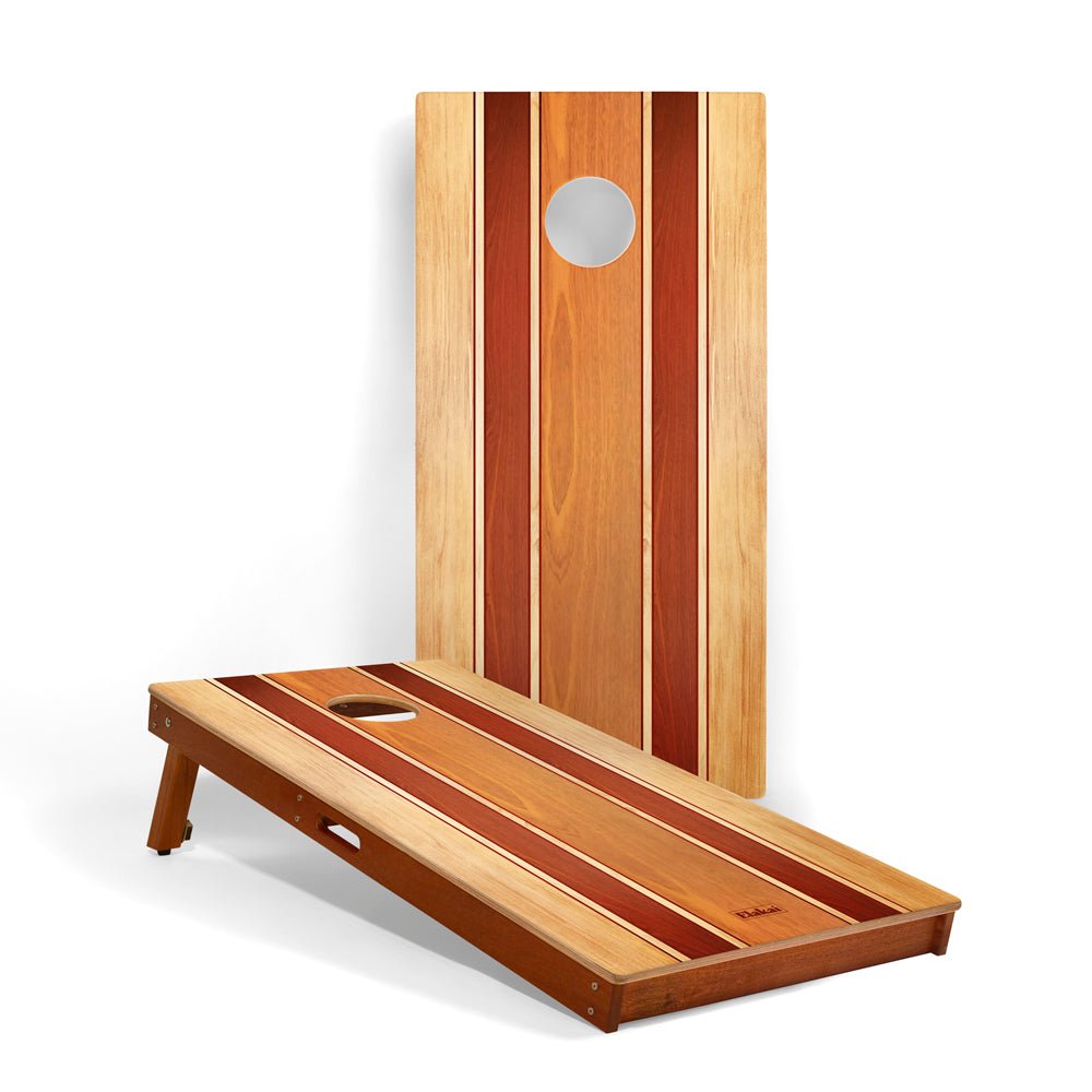 Wooden cornhole board with striped design on a white background