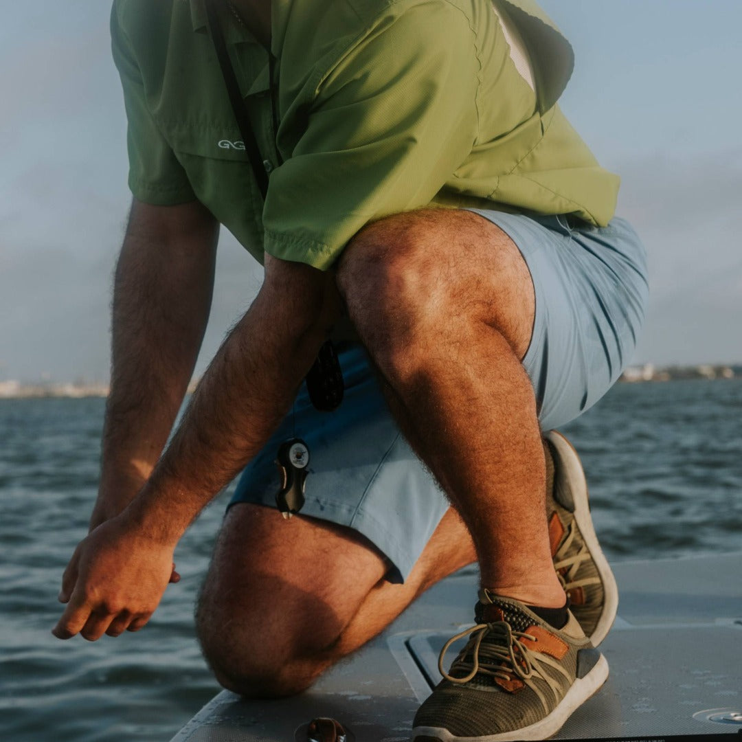 Person sitting on a boat with water in the background