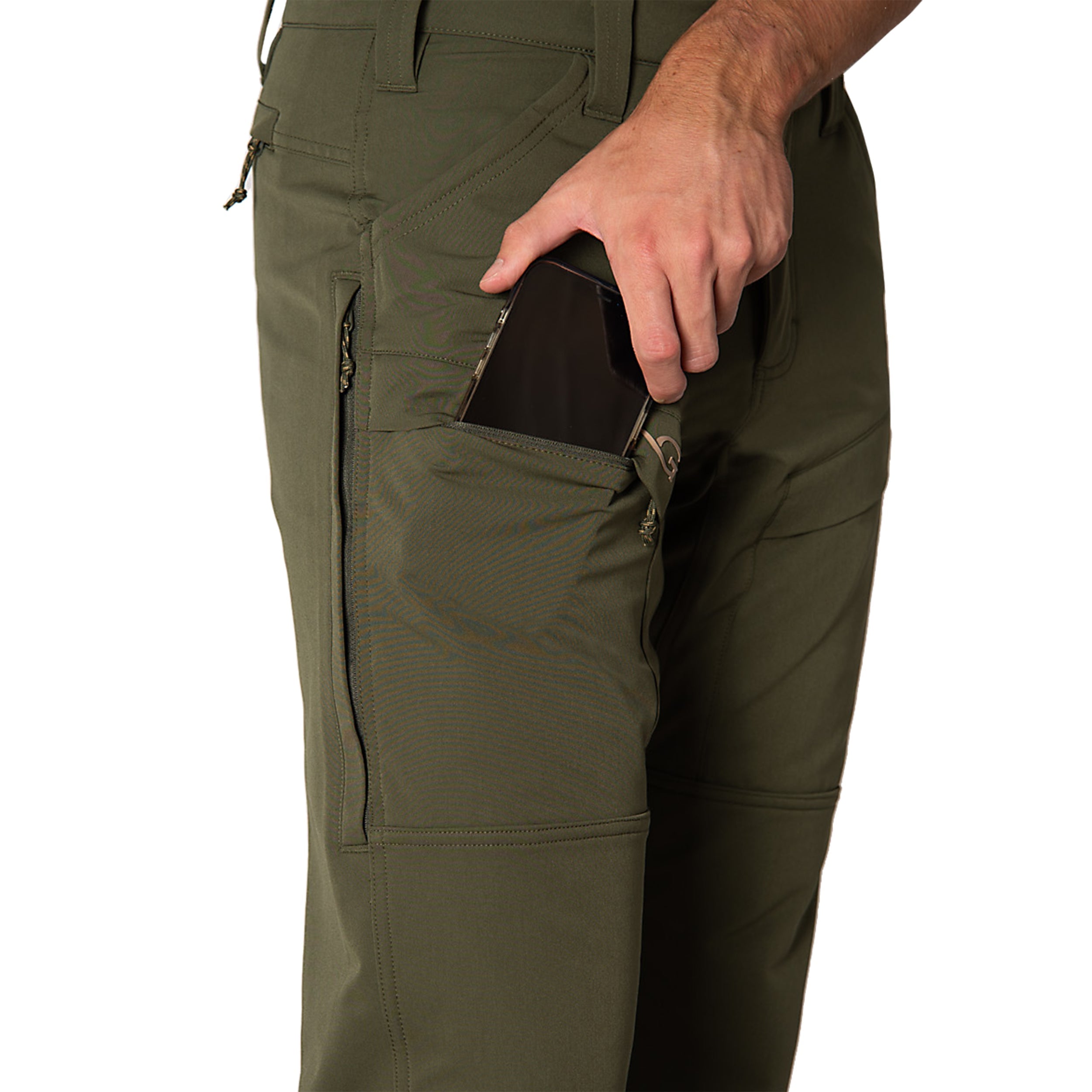 Person wearing olive green pants with a hand in a pocket on a white background