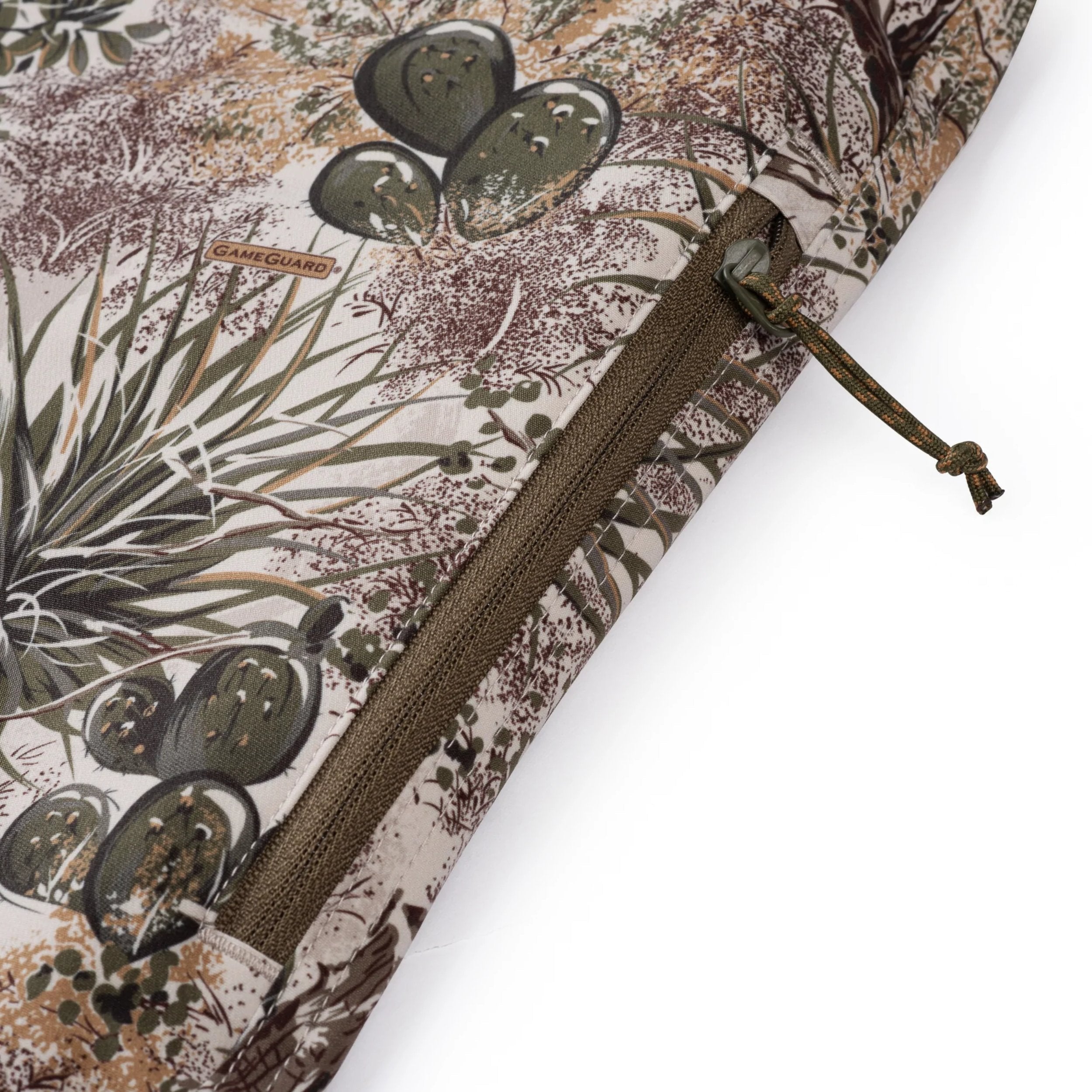 Close-up of a patterned fabric with a zipper, featuring nature-themed design.