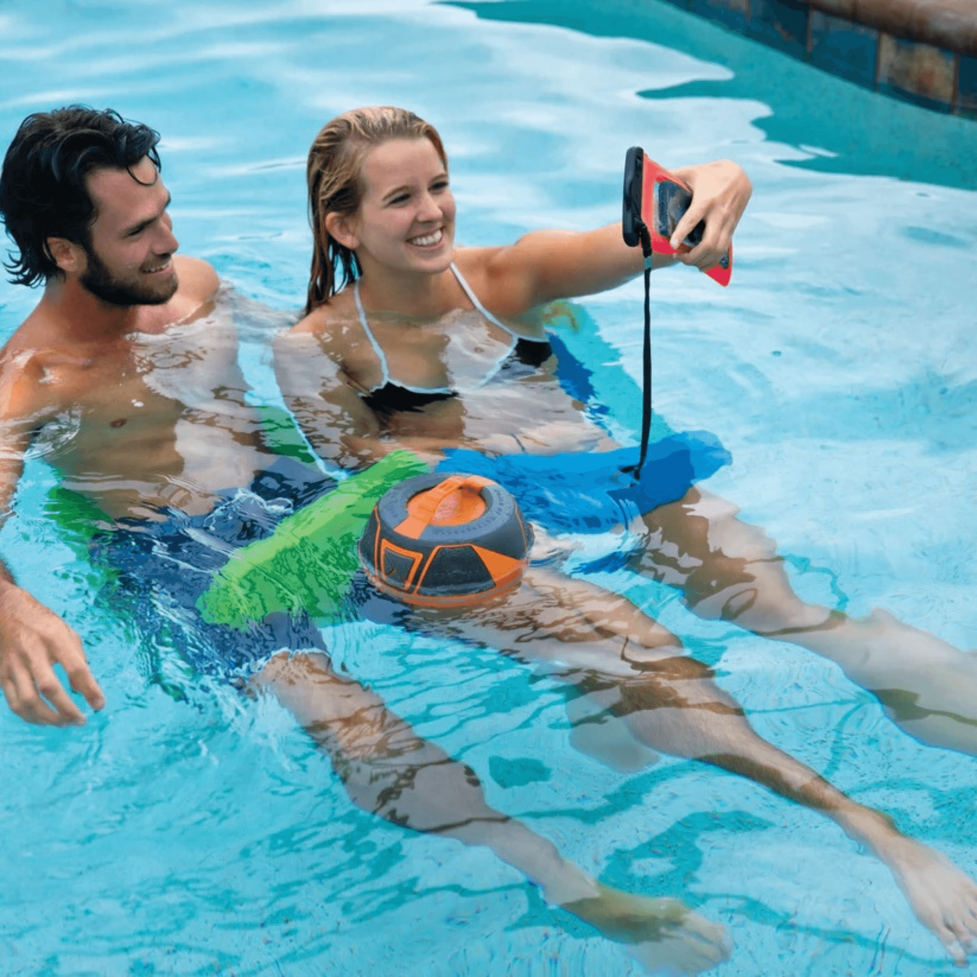 Two people in a pool with a ball and a device, possibly for water activities.