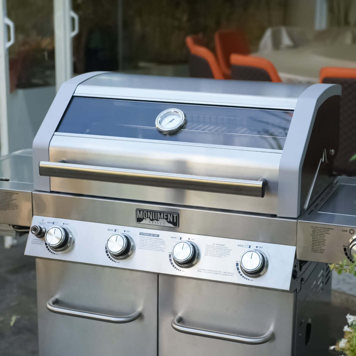 Stainless steel grill with brand logo on an outdoor setting