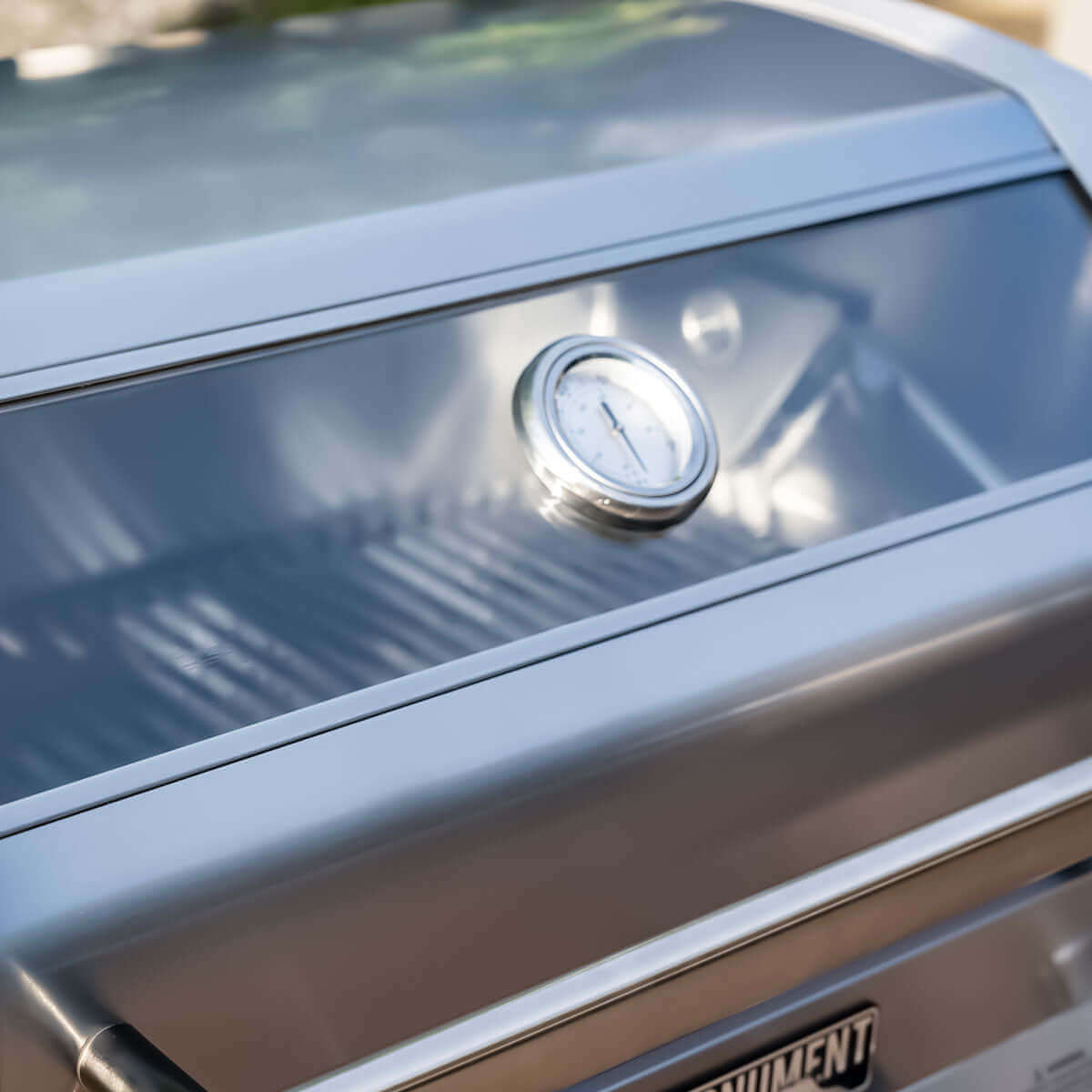 Close-up of a grill with a thermometer on a metal surface