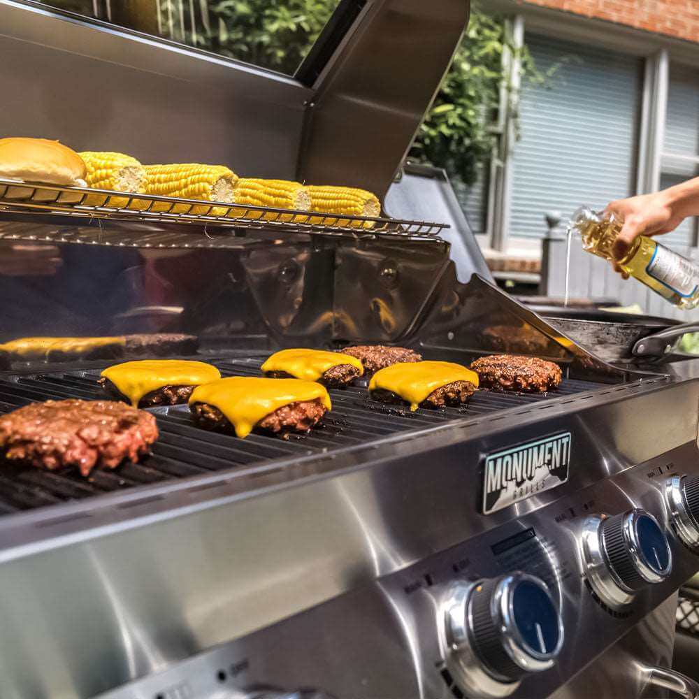 Grilling burgers with cheese and corn on a backyard barbecue