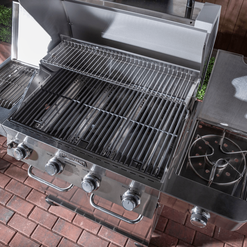 Stainless steel grill with multiple burners on a brick patio