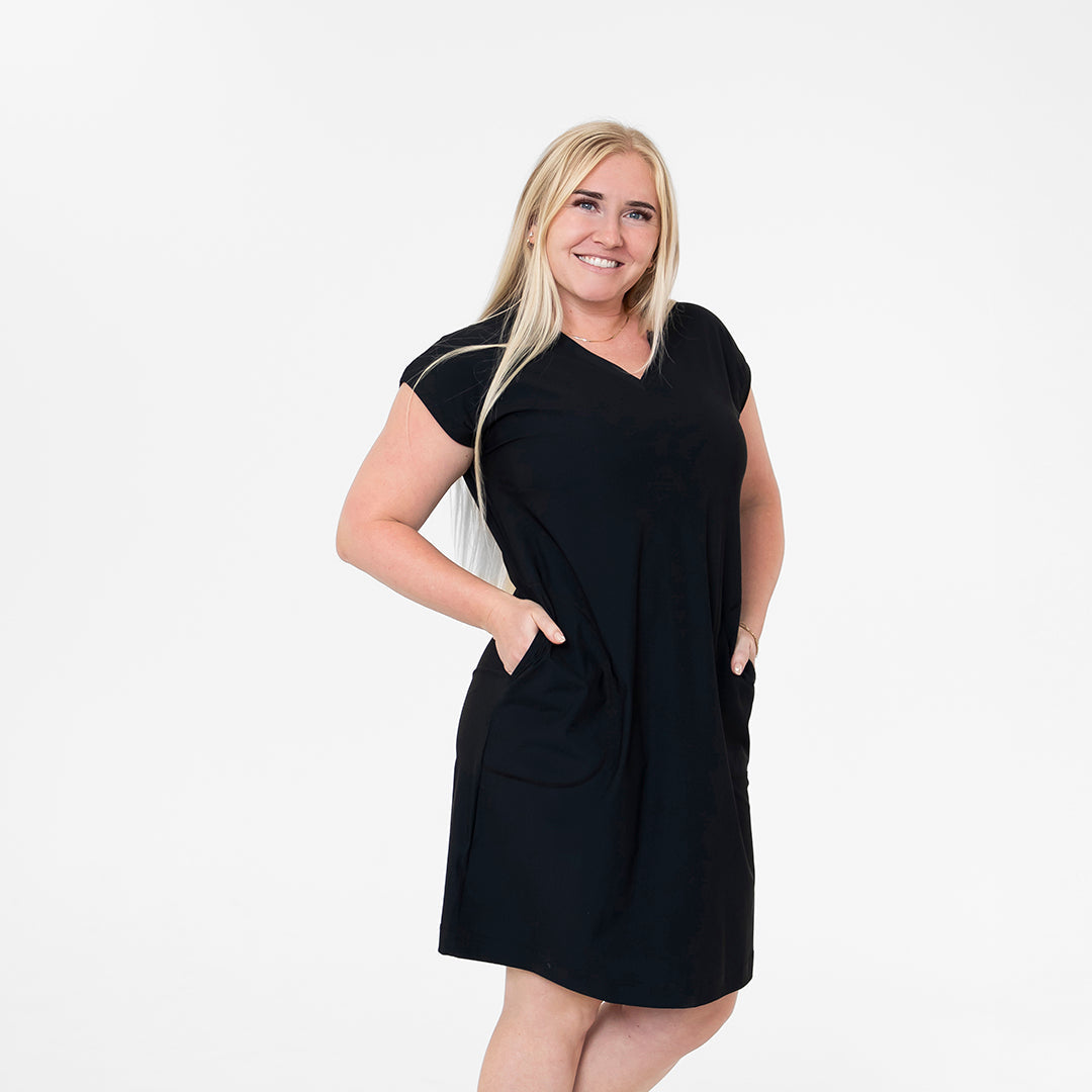 Woman wearing a black dress on a white background