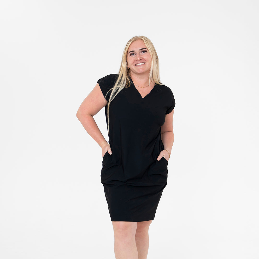 Woman wearing a black dress on a white background