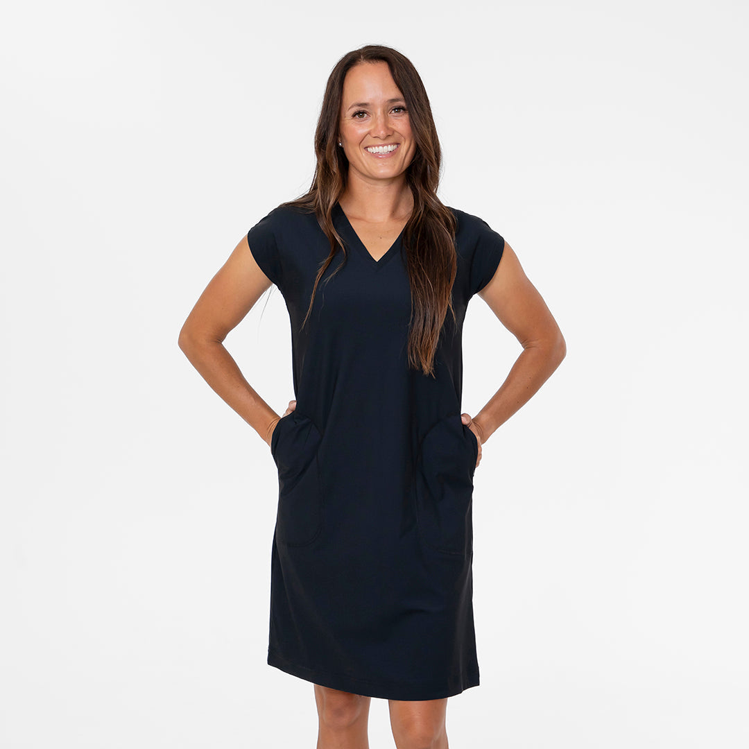 Woman wearing a navy blue dress on a white background