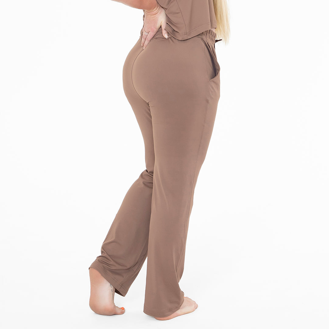Brown pants worn by a person on a white background