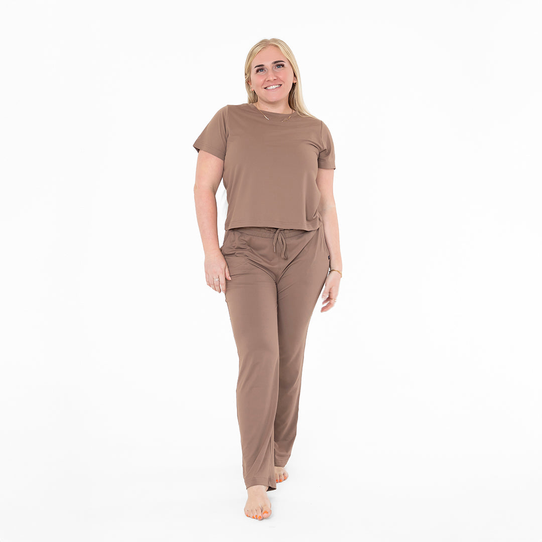 Woman wearing a brown outfit on a white background