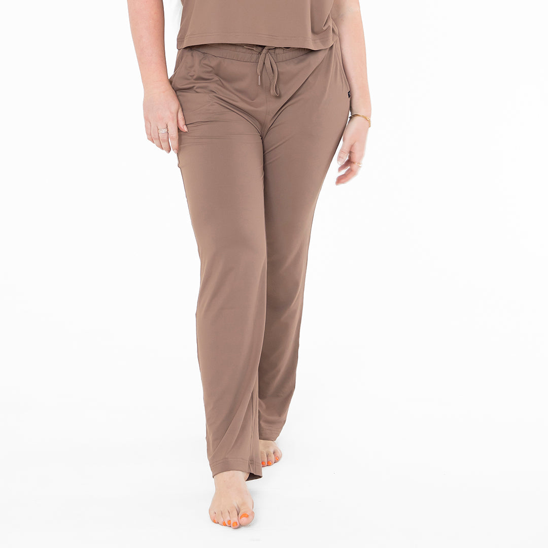 Brown lounge pants worn by a person on a white background