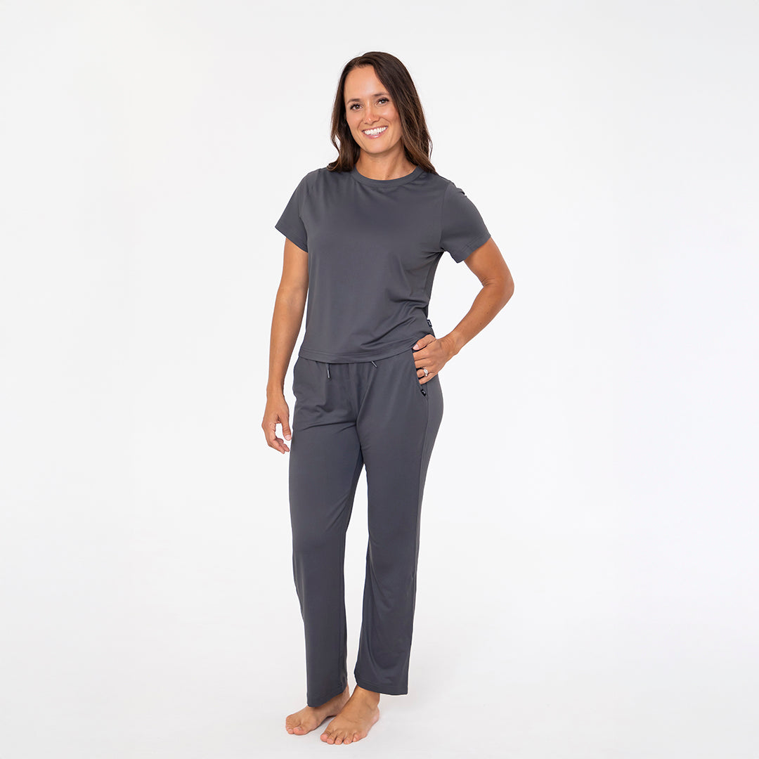 Woman wearing a gray pajama set on a white background