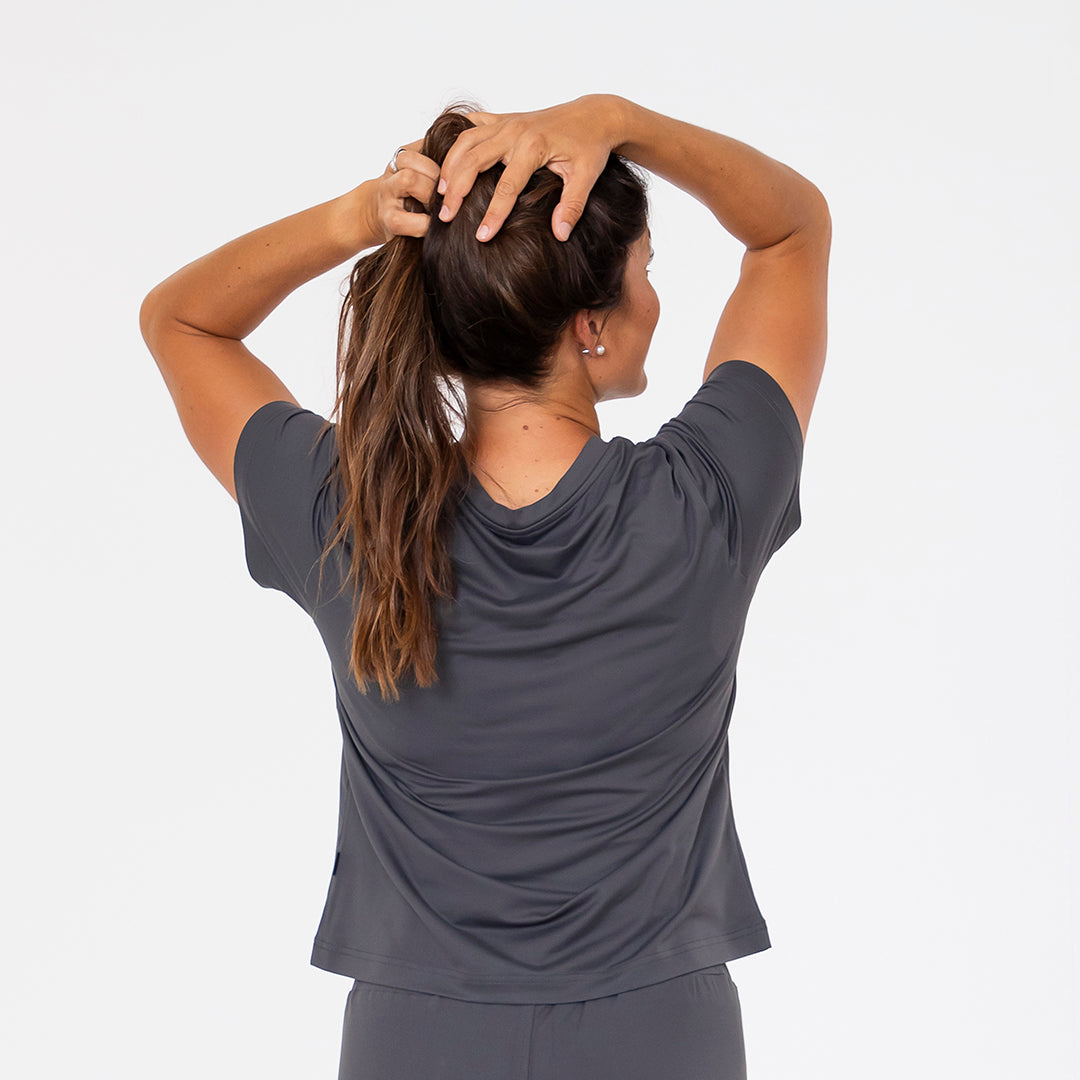 Person wearing a gray athletic outfit against a white background