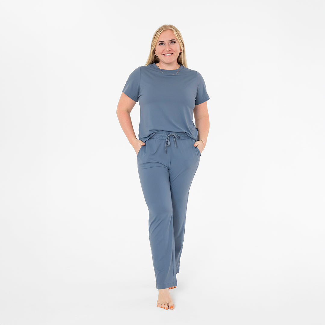 Woman wearing a blue pajama set on a white background