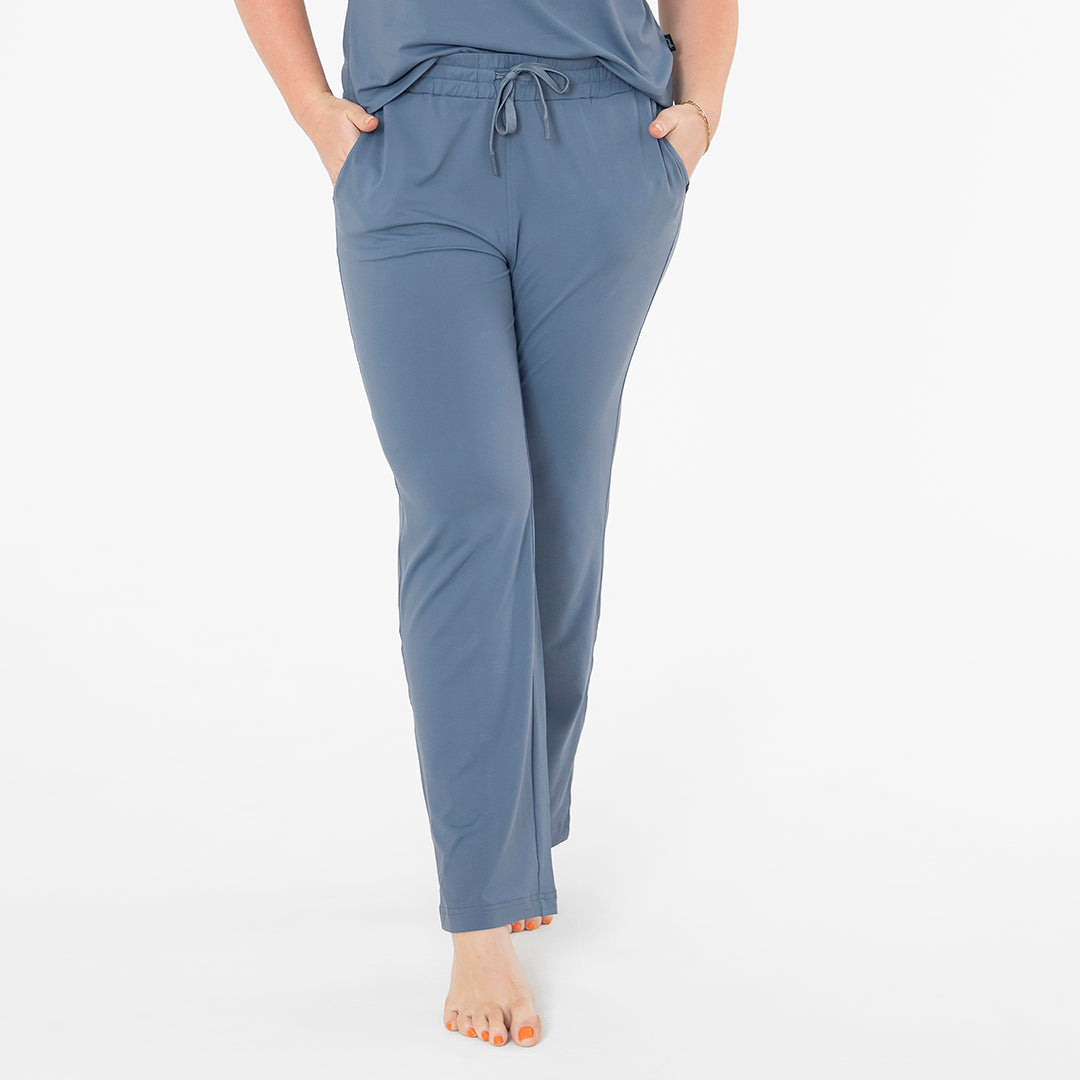 Blue pants worn by a person on a white background