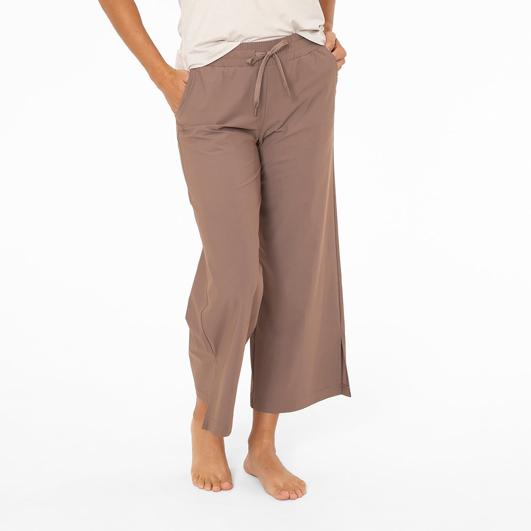 Brown pants worn by a person on a white background