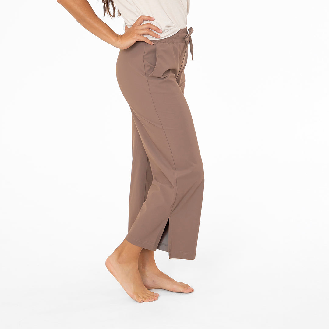 Brown pants worn by a person on a white background