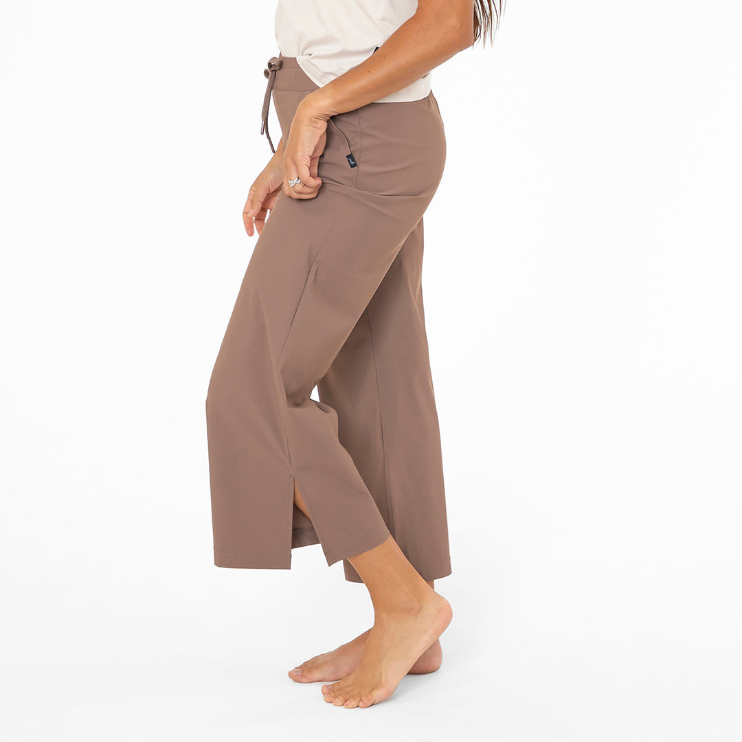 Brown wide-leg pants worn by a person on a white background