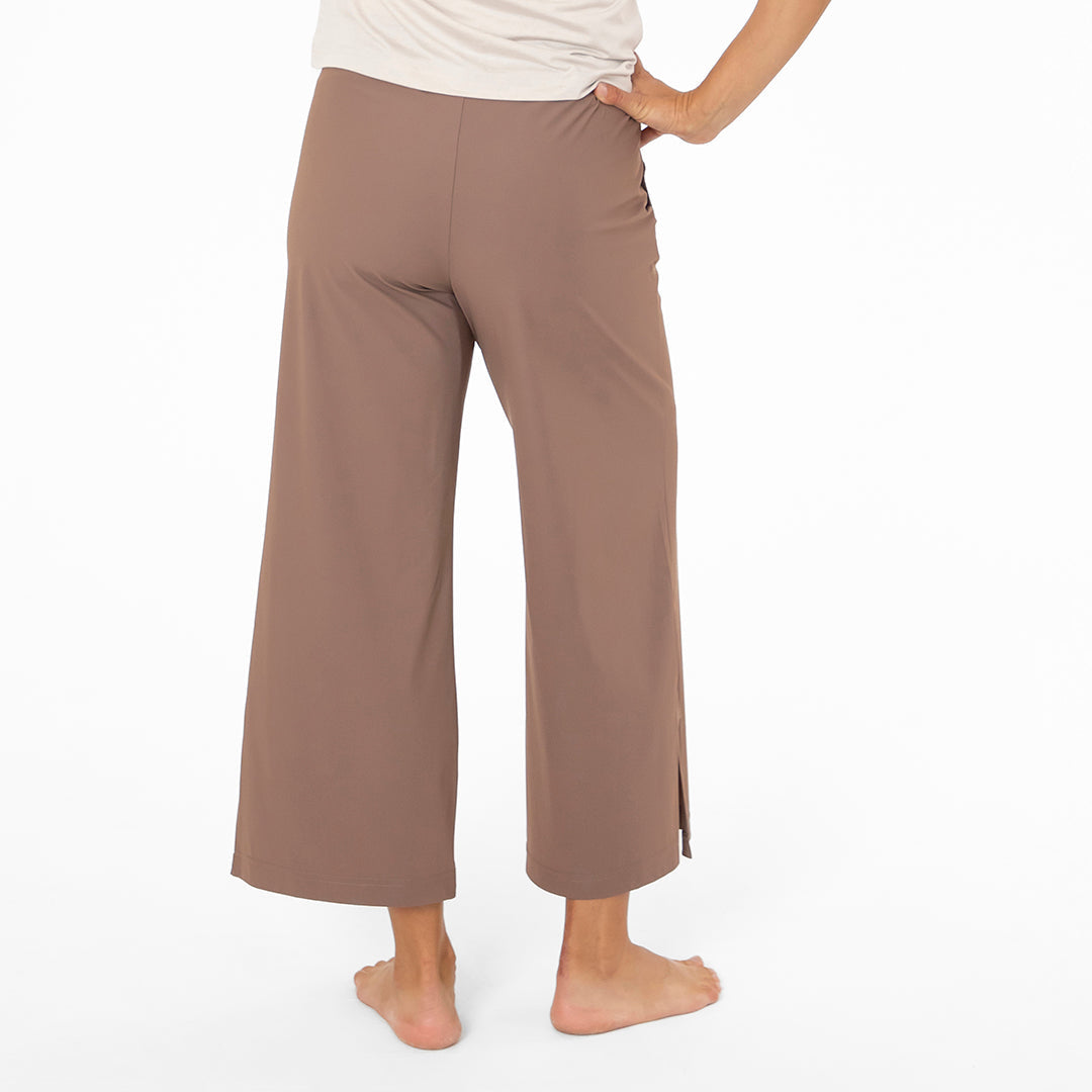 Brown wide-leg pants worn by a person on a white background