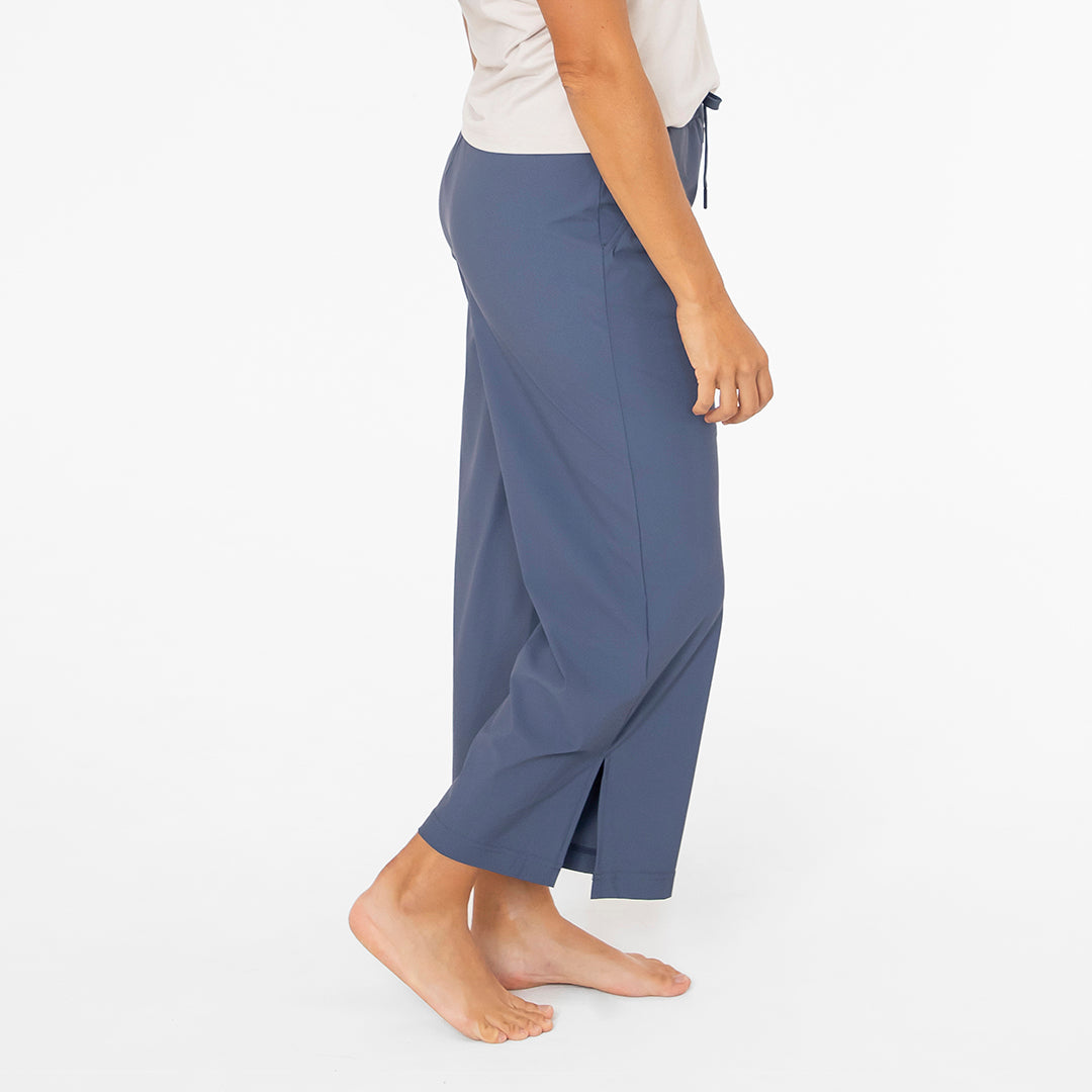 Person wearing blue pants on a white background