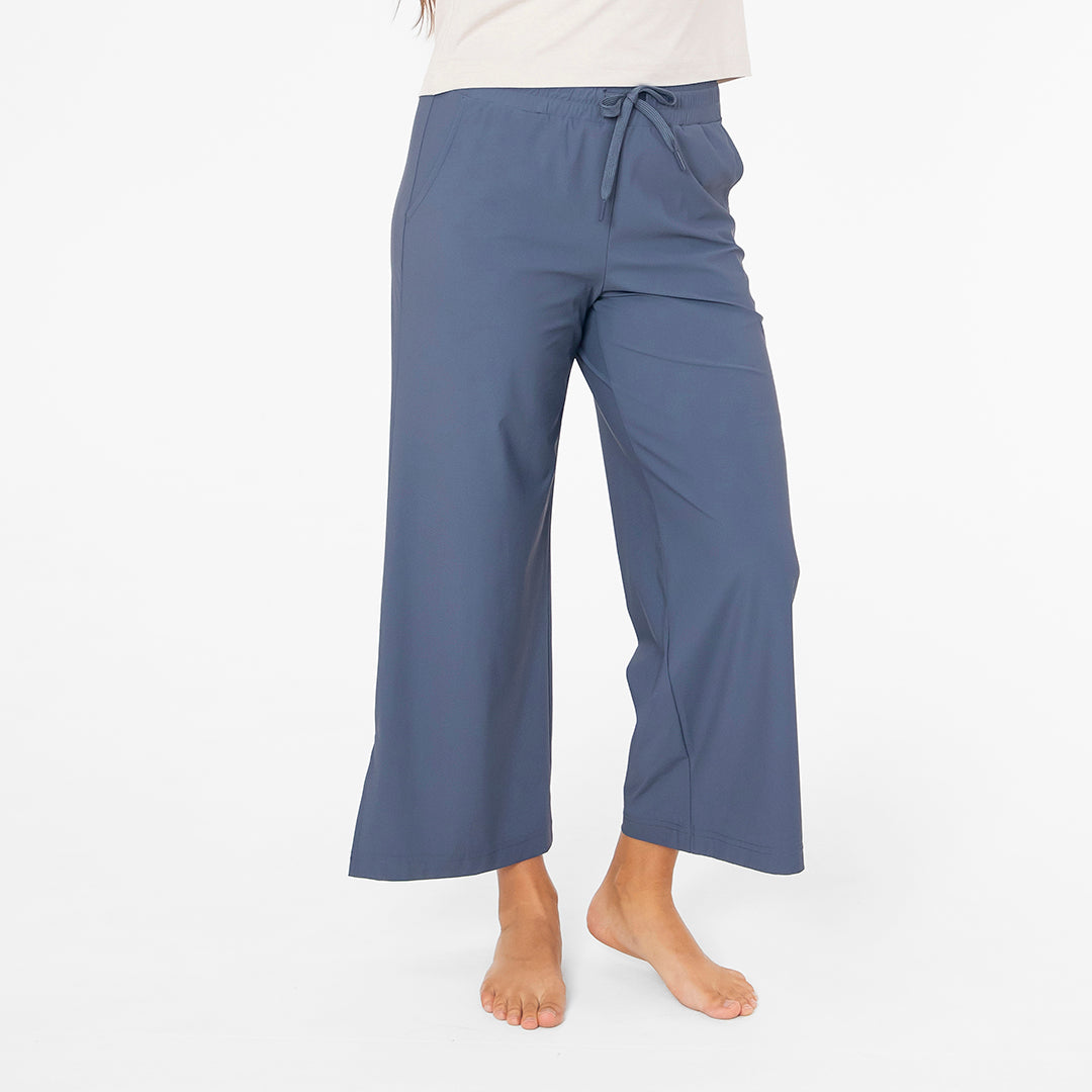Blue pants worn by a person on a white background