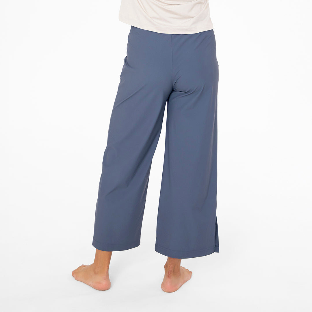 Blue wide-leg pants worn by a person on a white background