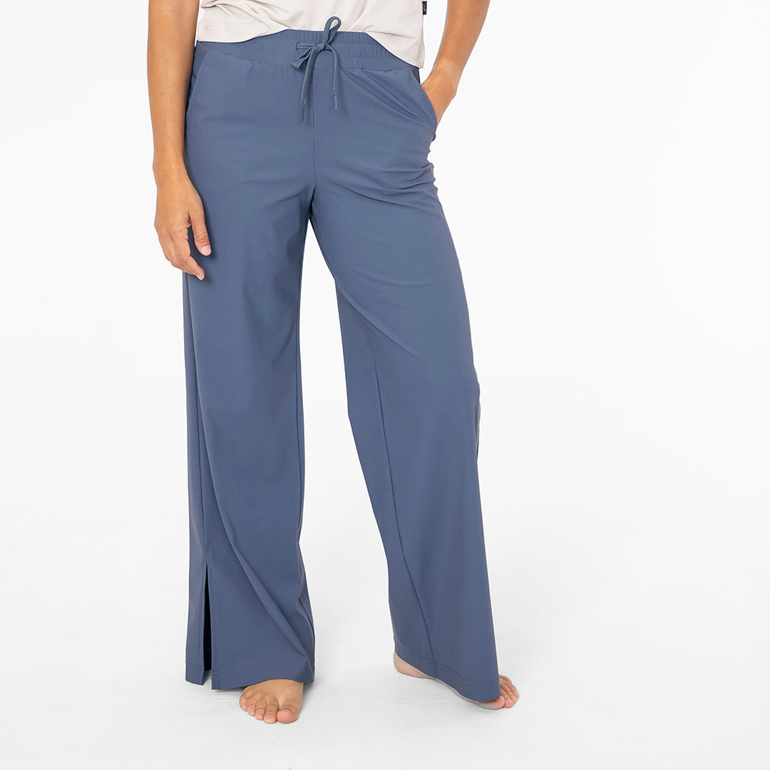 Blue wide-leg pants worn by a person on a white background