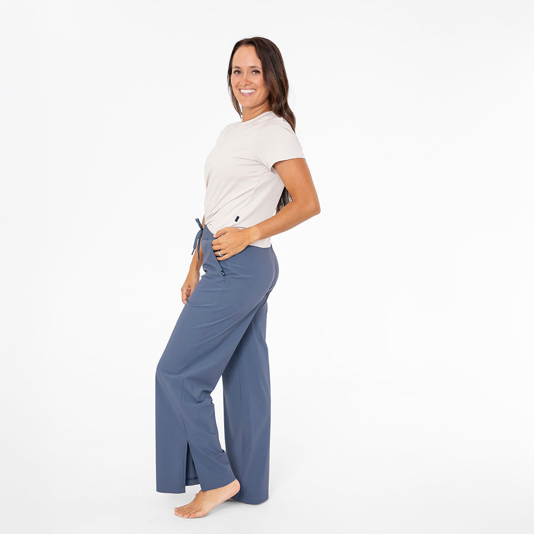 Woman wearing a white shirt and blue pants on a white background