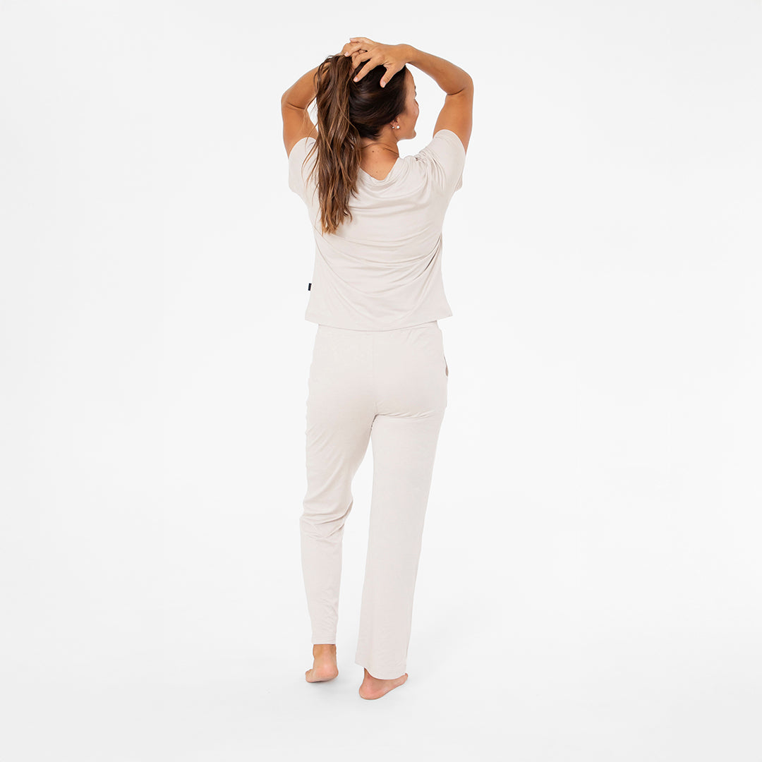 Woman wearing a white loungewear set on a white background