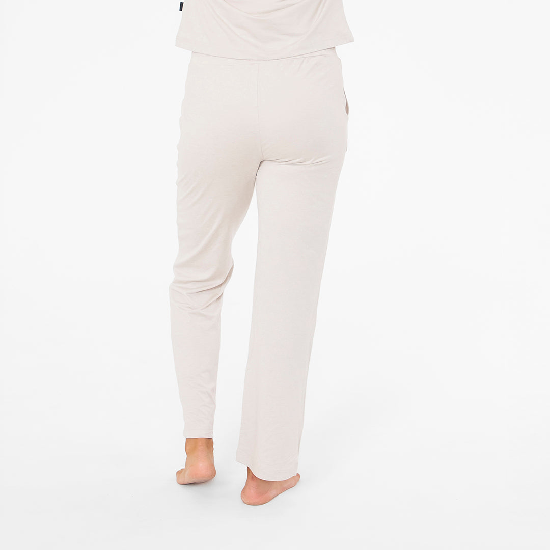 Person wearing light gray pants on a white background