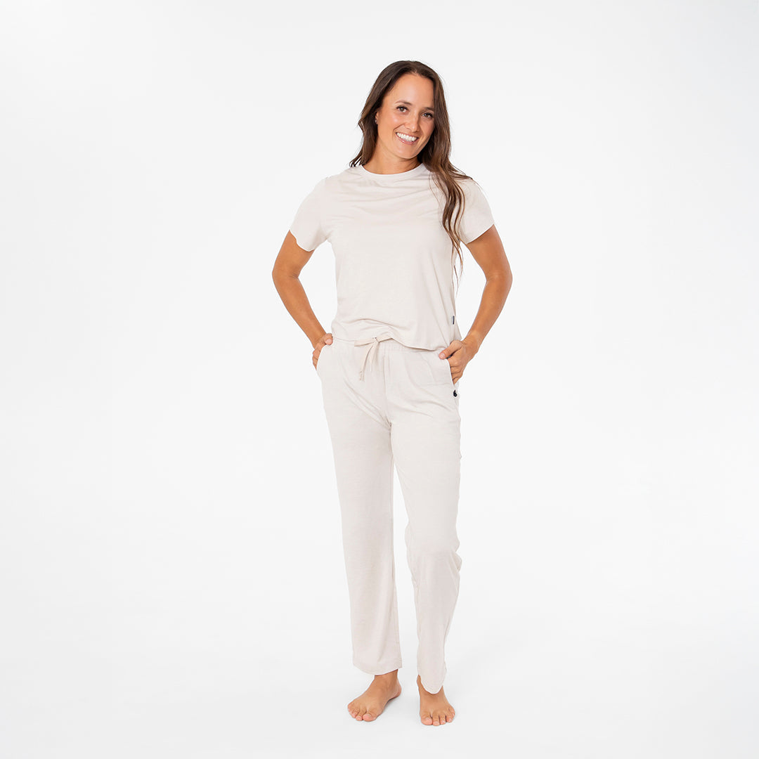 Woman wearing a white outfit on a plain background