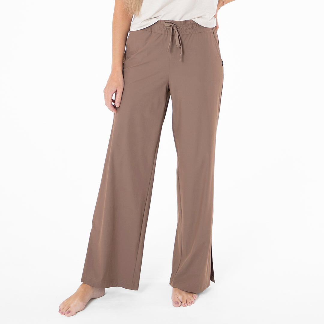Brown lounge pants worn by a person on a white background