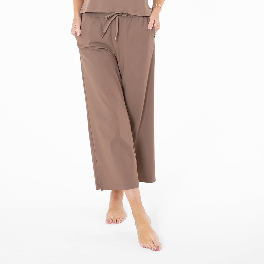 Brown pants worn by a person on a white background