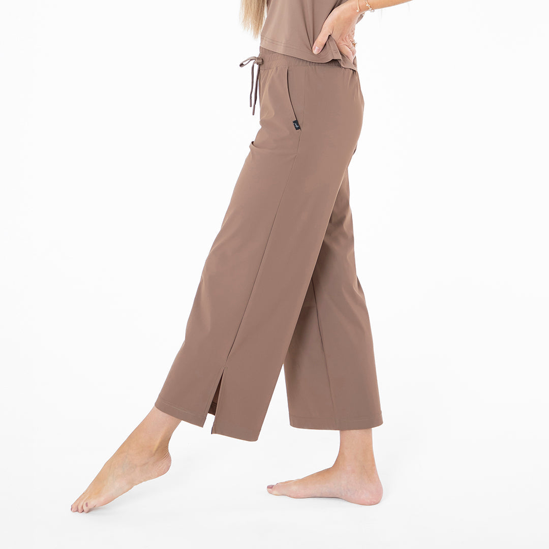 Brown wide-leg pants worn by a person on a white background