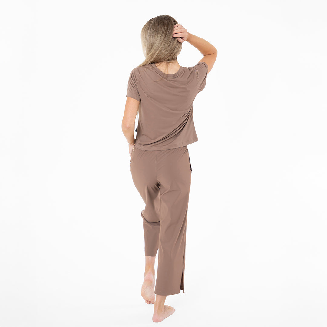 Woman wearing a brown outfit on a white background