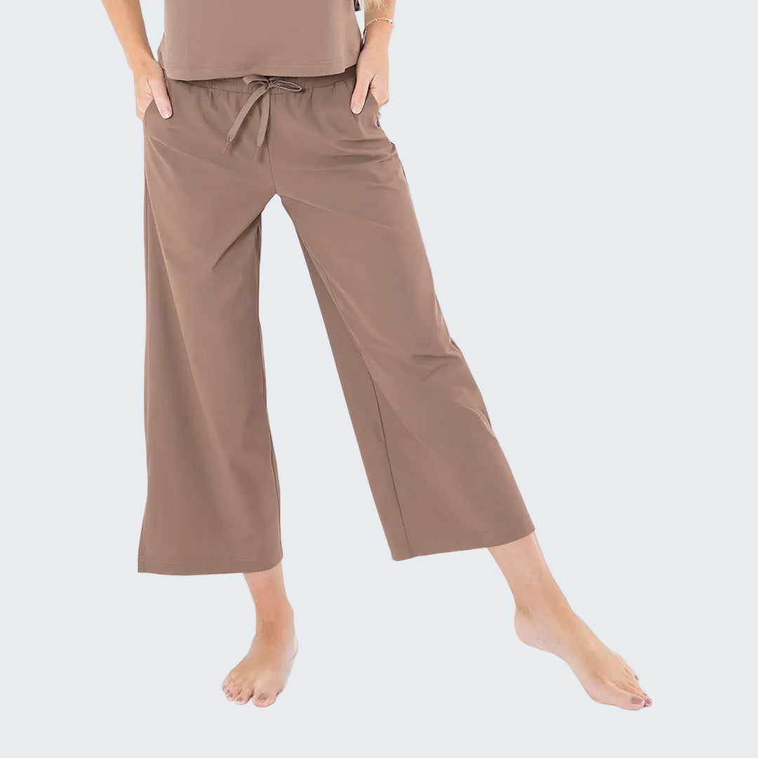 Brown wide-leg pants worn by a person on a white background