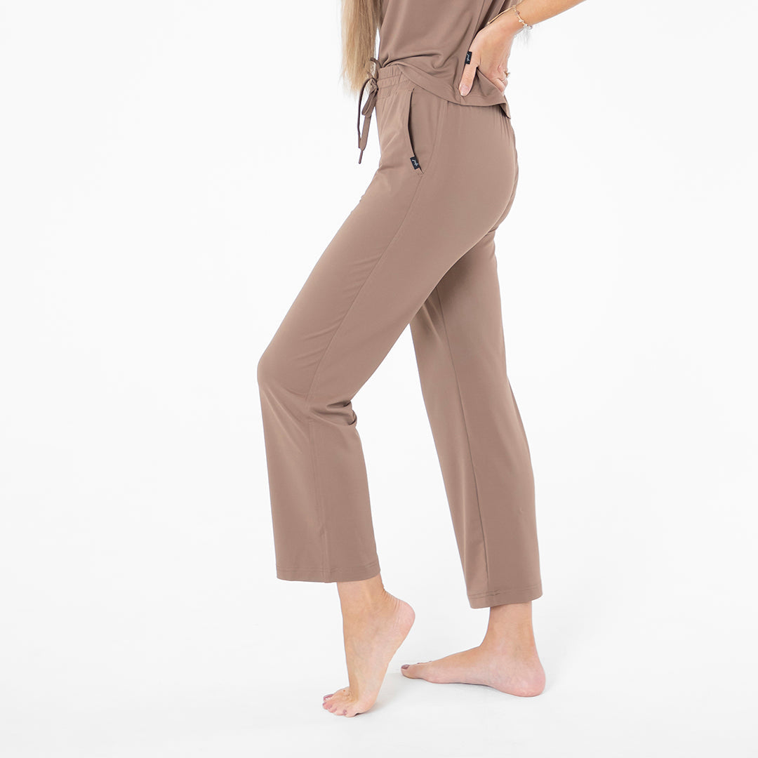 Person wearing a brown outfit on a white background