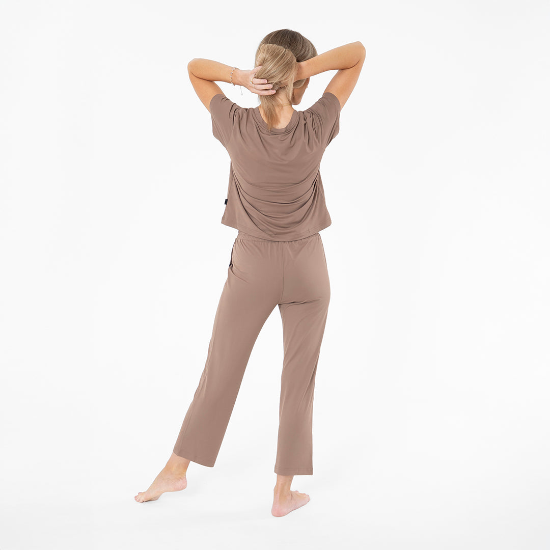 Woman wearing a brown outfit on a white background