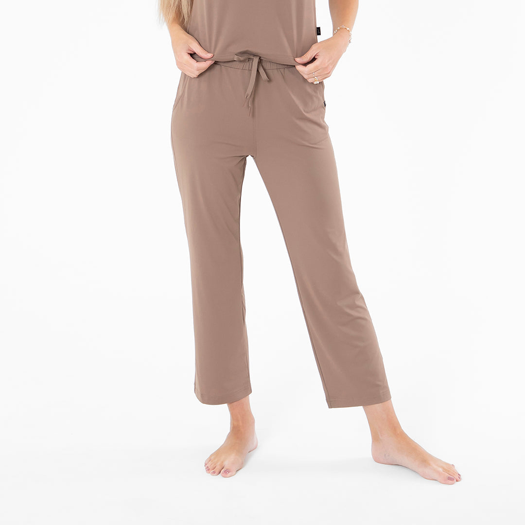 Brown jumpsuit worn by a person on a white background