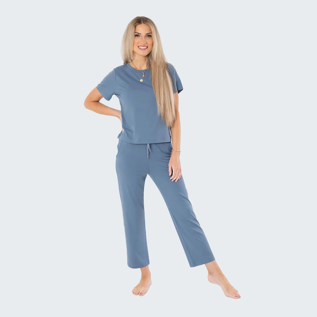 Woman wearing a blue pajama set on a white background