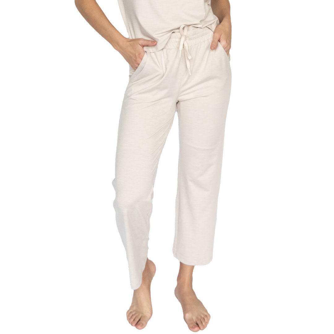 White pants worn by a person on a white background
