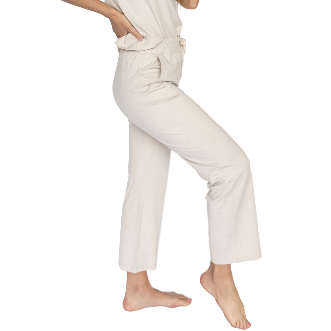 Person wearing beige pants on a white background